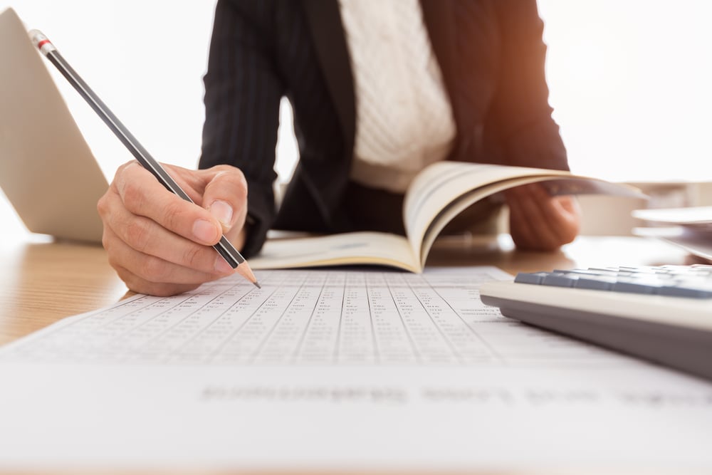 Female auditor checking business figures