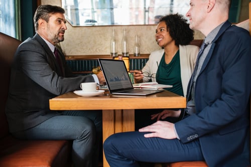 2 men and 1 woman having a breakfast meeting