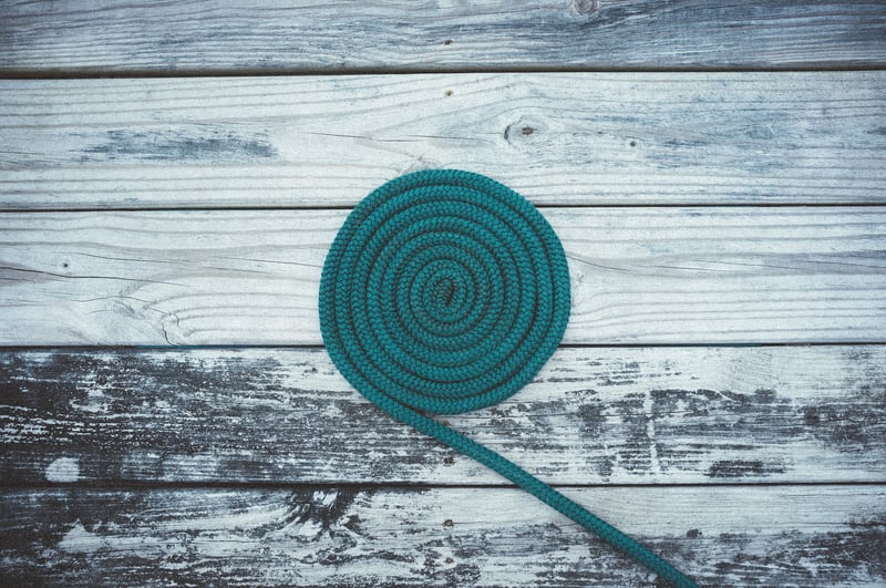 a roll of green rope on a deck