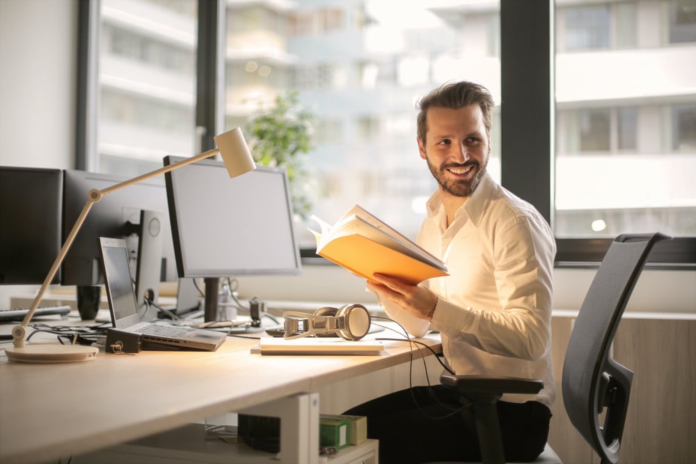 Smiling business person sitting at desk