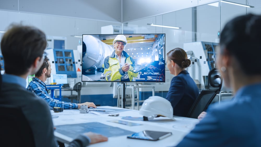 Female engineer on screen at meeting