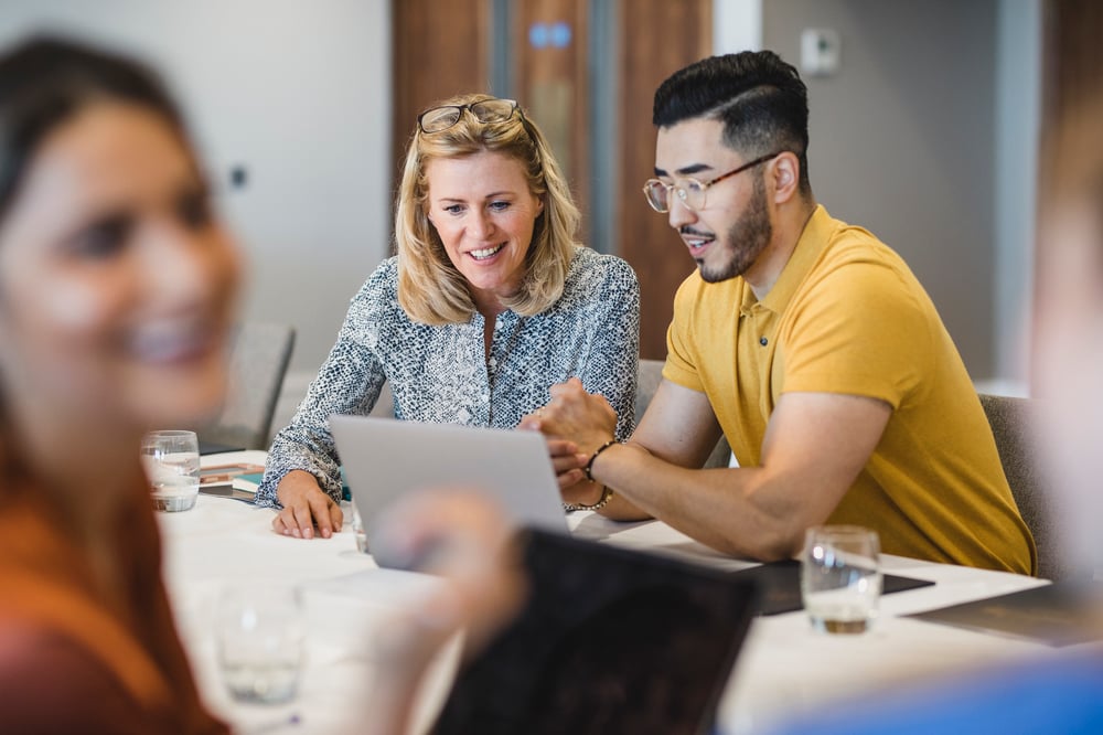 Man and woman looking at laptop