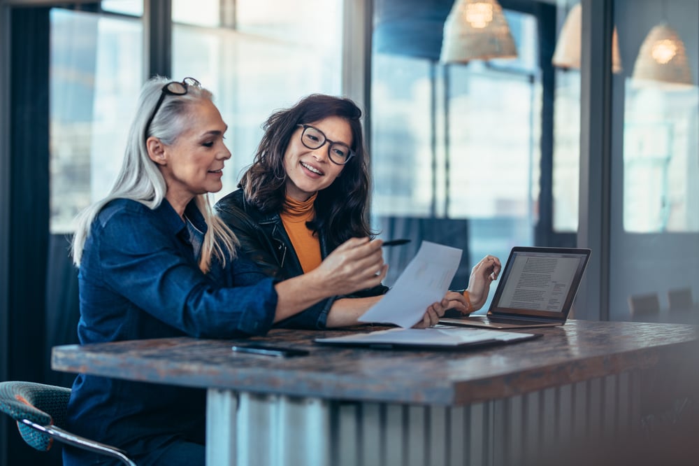 Two women looking at documents