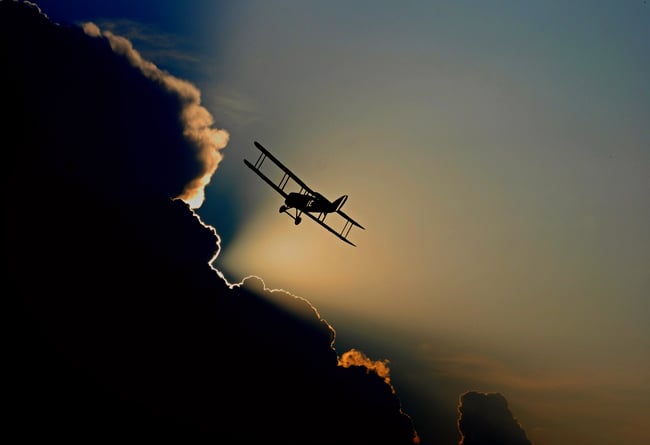 Biplane flying into clouds