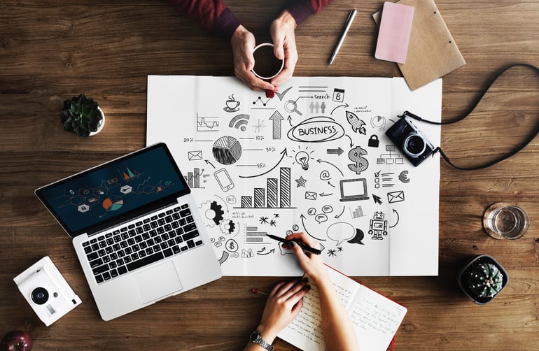 Photo from above of two people working on business strategy