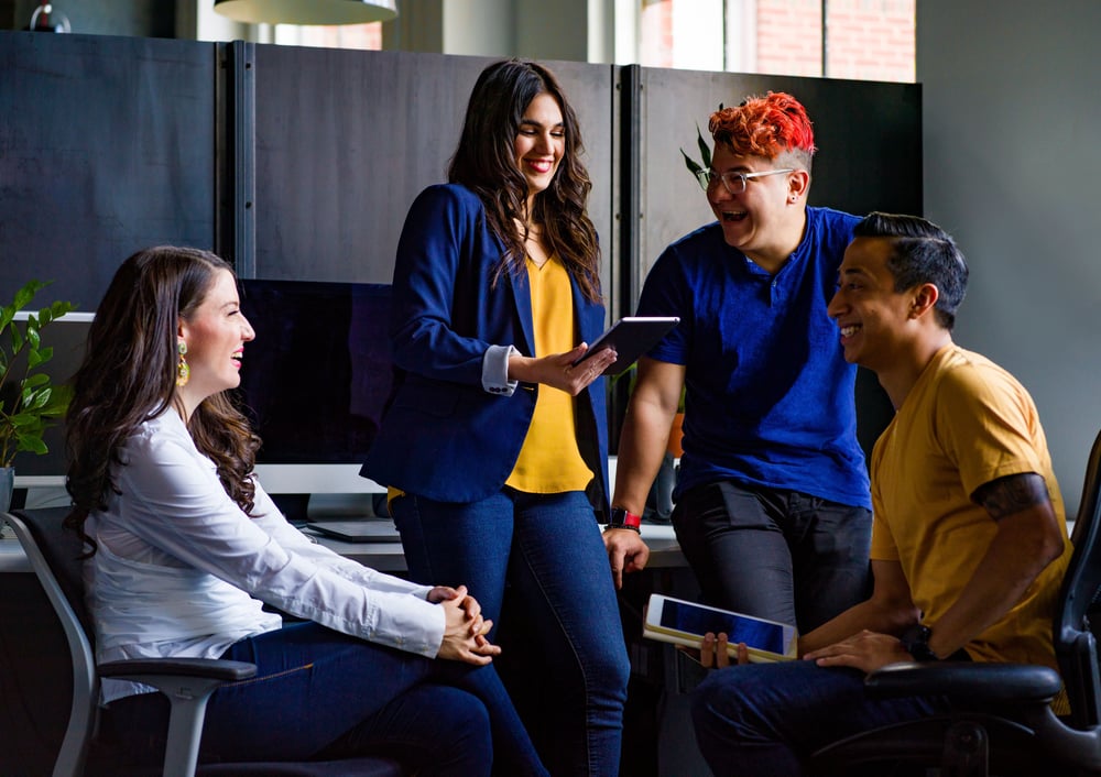 Group of people sitting and laughing in an office